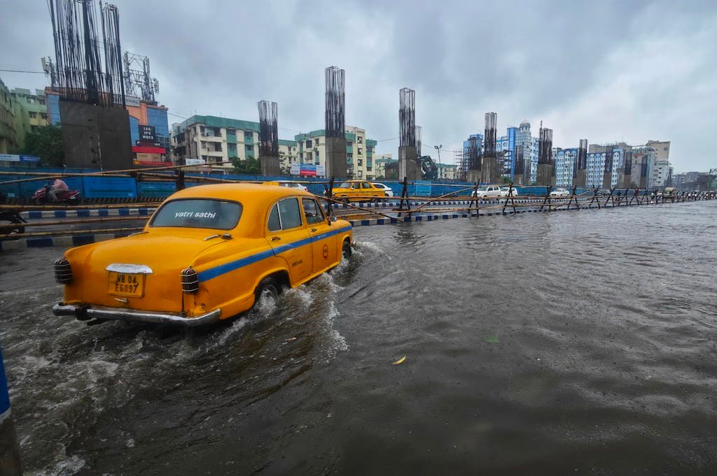 Cars Driving through a Flooded Street
